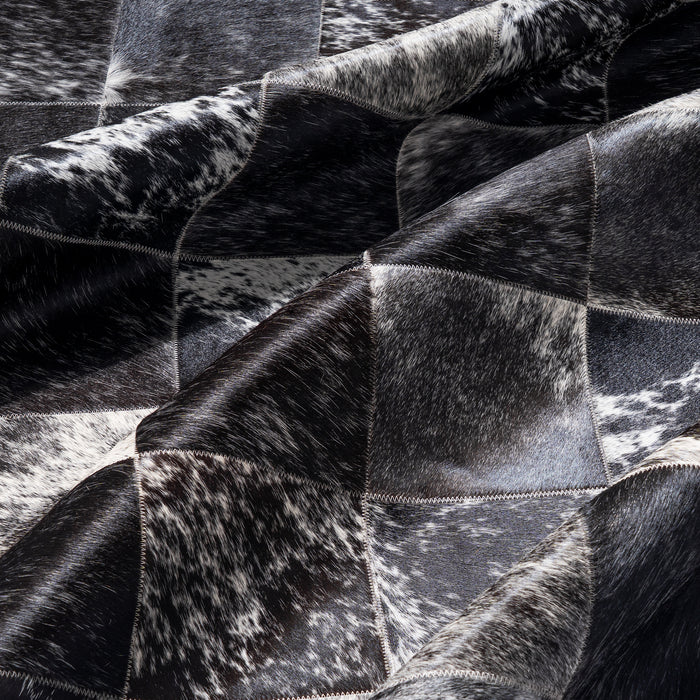 Close-up of a black and white cowhide rug with patchwork pattern