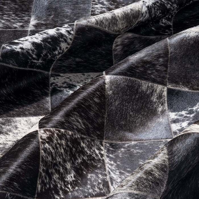 Close-up of a black and white cowhide rug with patchwork pattern