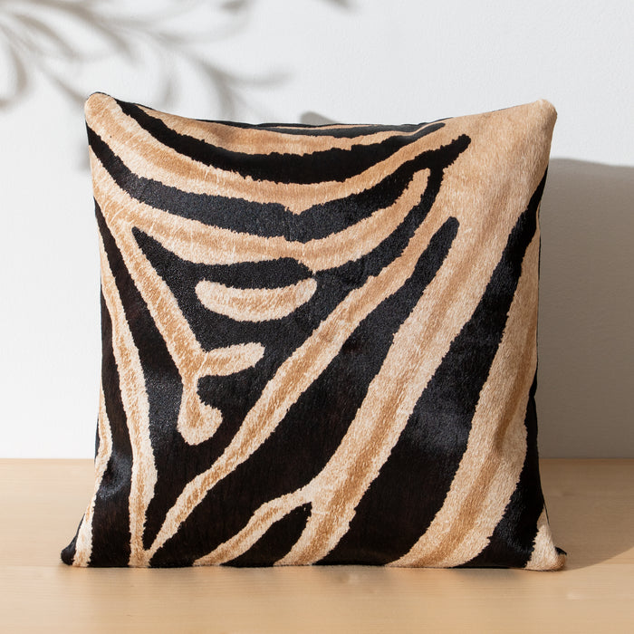 Decorative cowhide pillow with zebra safari pattern on a neutral background