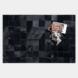 Rhodes black patchwork cowhide rug styled in a living room