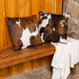 Set of tricolor cowhide pillows styled together