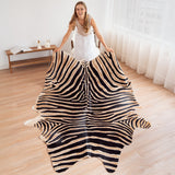 Zebra safari cowhide rug laid flat on a hardwood floor
