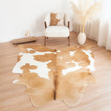 Wide shot of palomino and white cowhide rug anchoring a living room seating area