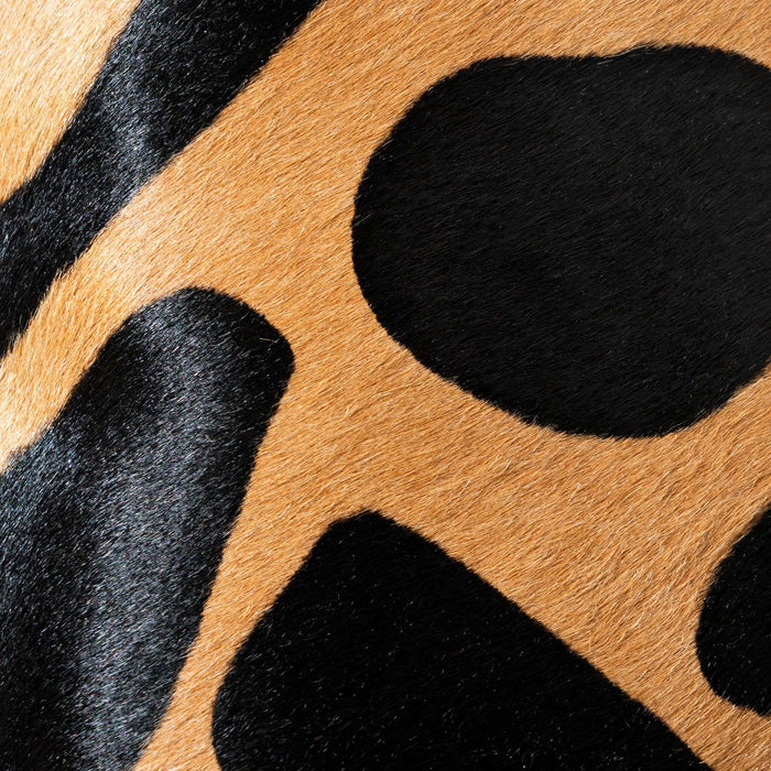 Close-up of a giraffe print pattern with black and brown colors.