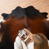 Mahogany cowhide rug styled in a modern living room