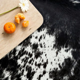 Natural suede leather backing on black salt and pepper cowhide rug