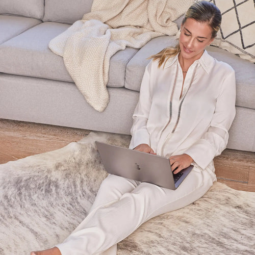 Grey brindle cowhide rug corner detail showing natural suede leather backing
