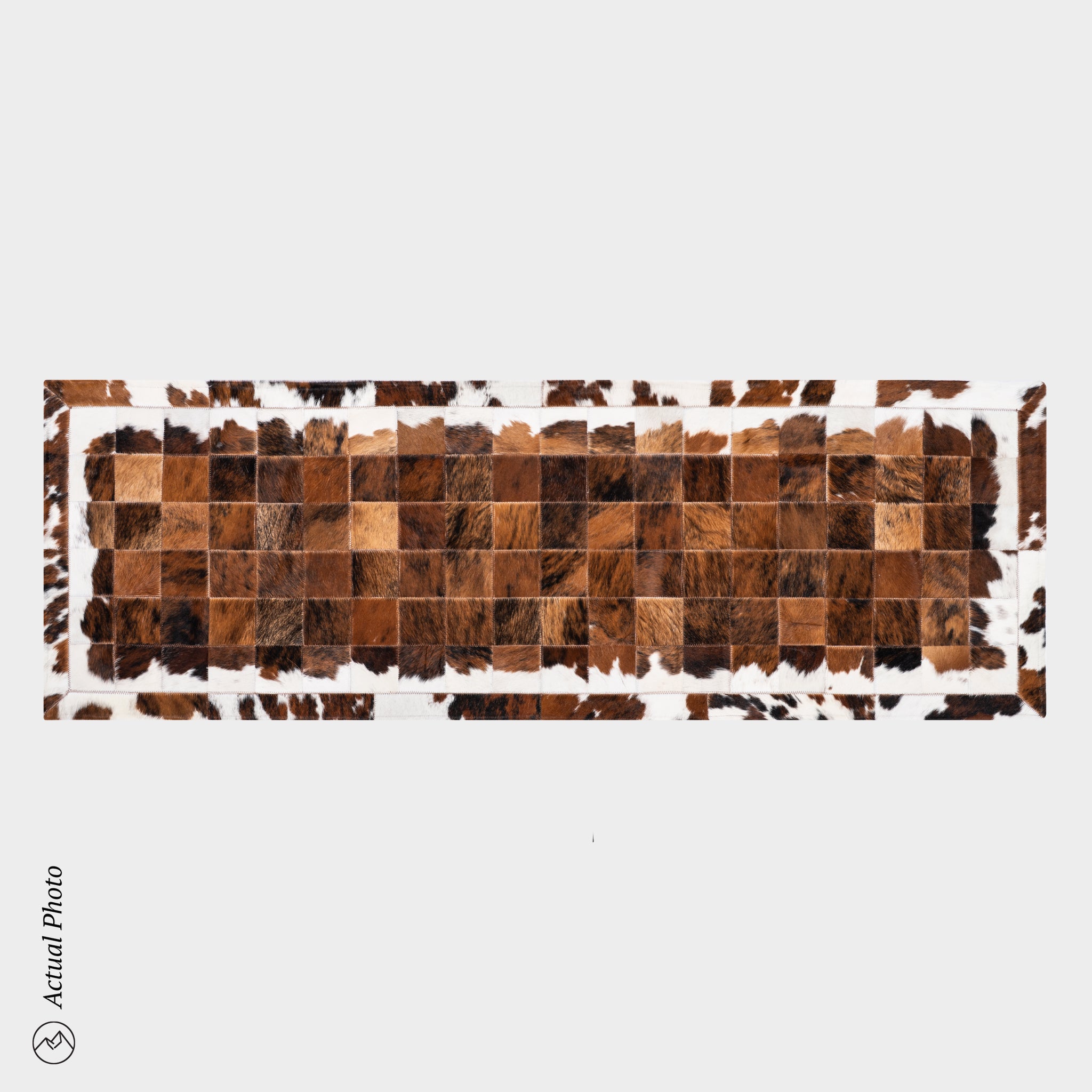 Rectangular patchwork runner with brown and beige squares on a white background