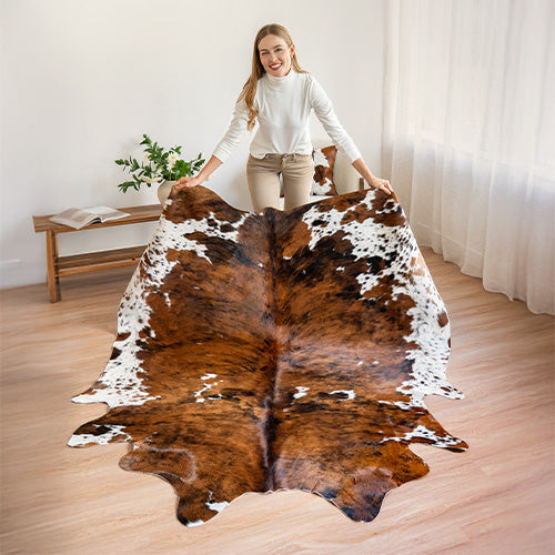 Woman holding a tricolor cowhide rug
