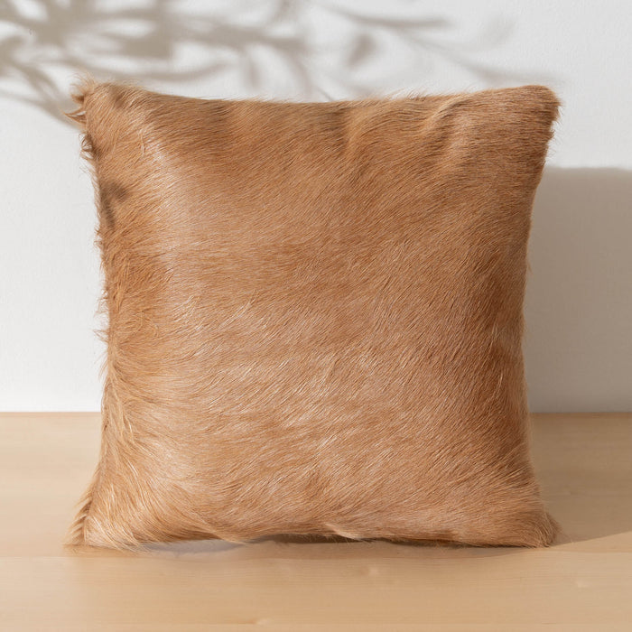 Brown fur pillow on a neutral background