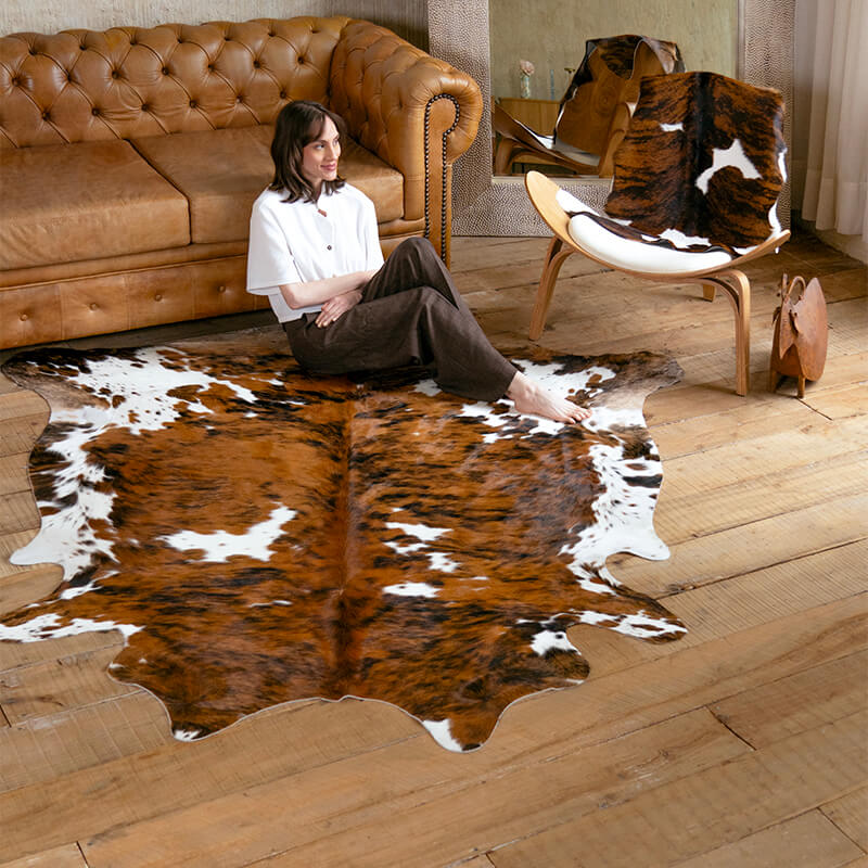 Model sitting on a cowhide rug